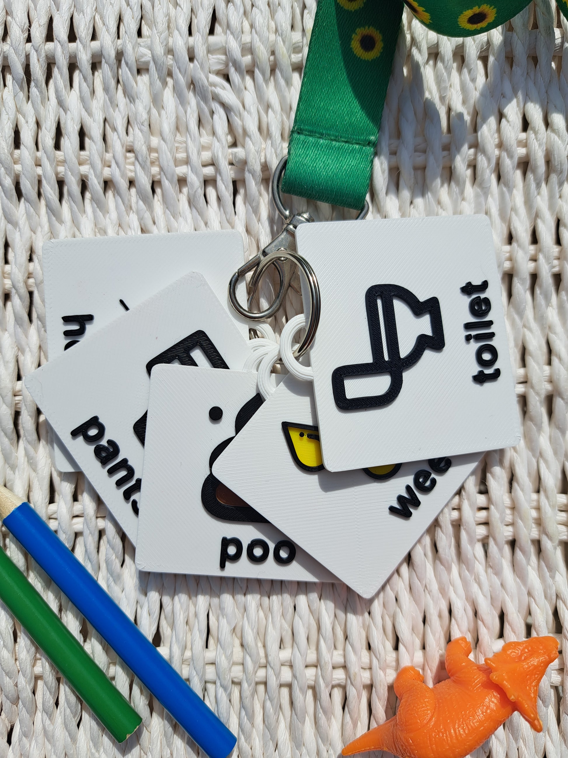 Toilet communication tag set with five 3D printed visual aid tags: toilet, wee, poo, pants, and help.