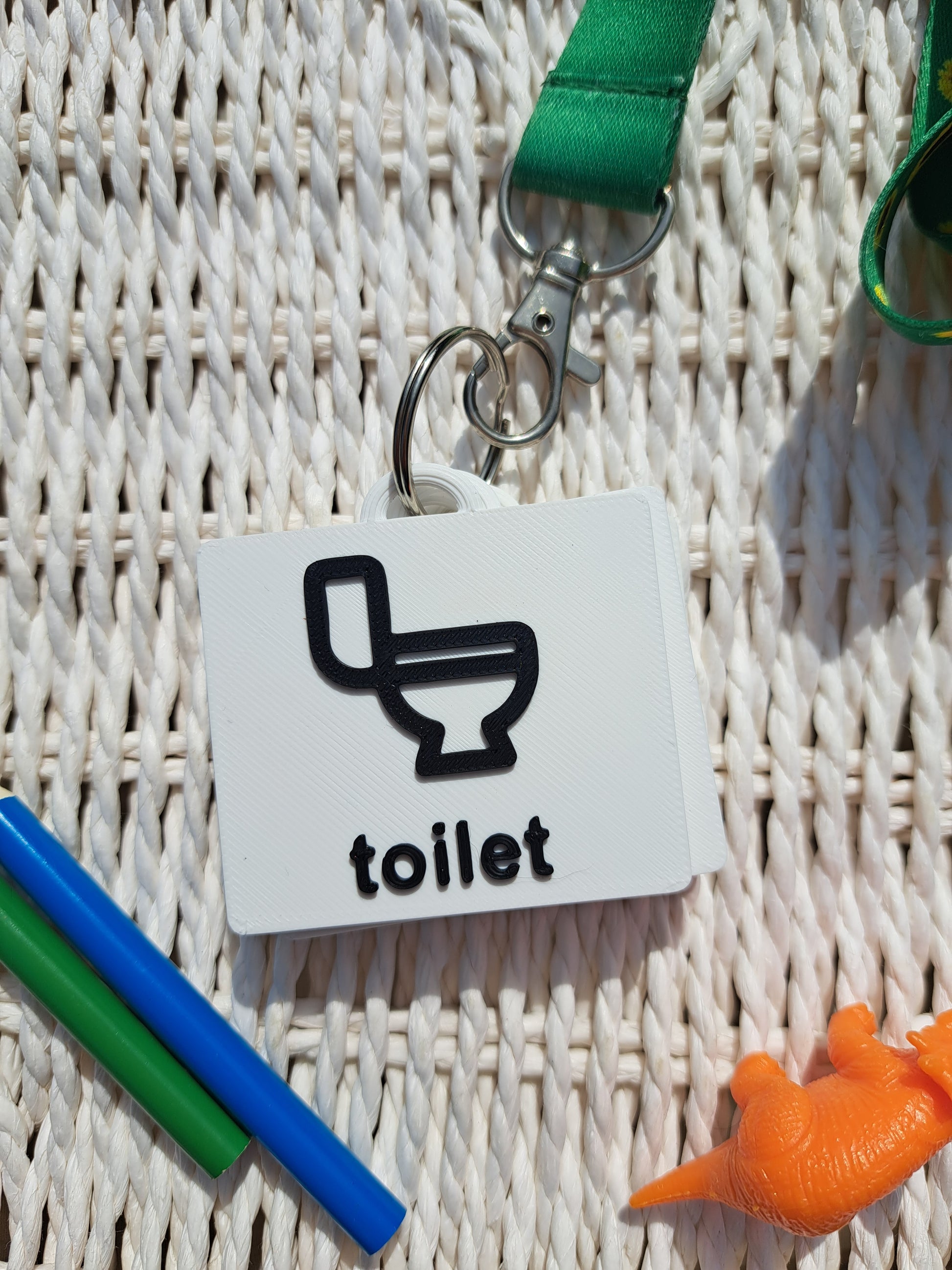 Close-up of the ‘Toilet’ tag from the toilet communication set, showing raised text and symbol.