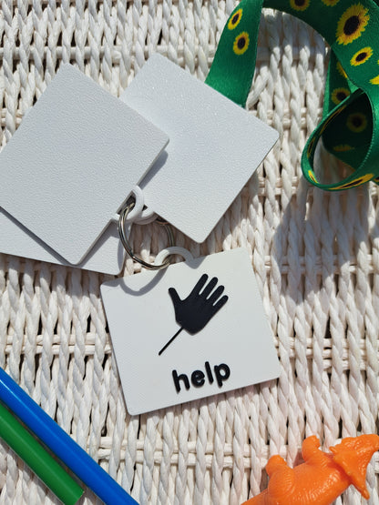 Close-up of the ‘Help’ tag from the toilet communication set, showing raised text and symbol.